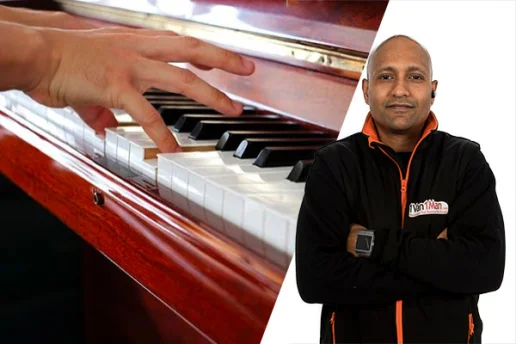 Specialist piano transport service in York moving an upright piano with protective wrapping.
